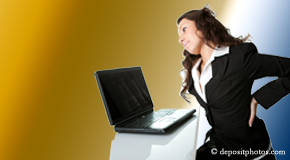 a person Largo bending over a computer holding her back due to pain